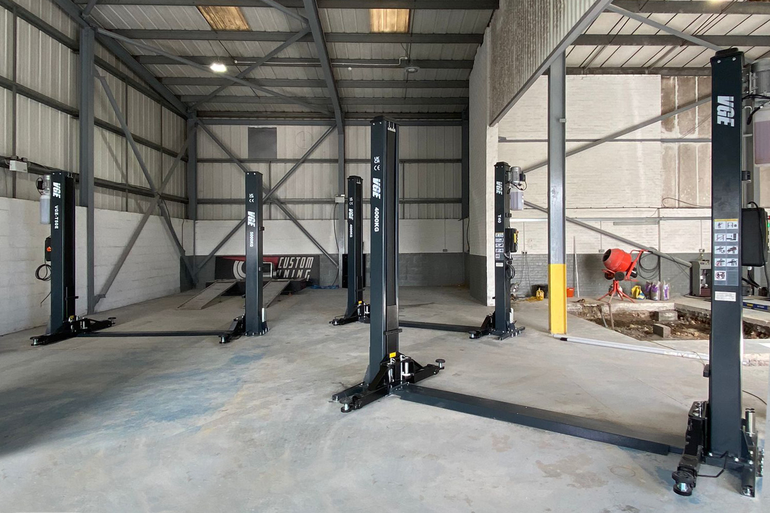 How to choose a 2-post lift for your workshop, including lift capacity, concrete depth, ceiling height, safety, installation, servicing and compliance.