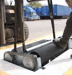 Brake testing roller system installed in a vehicle inspection bay.